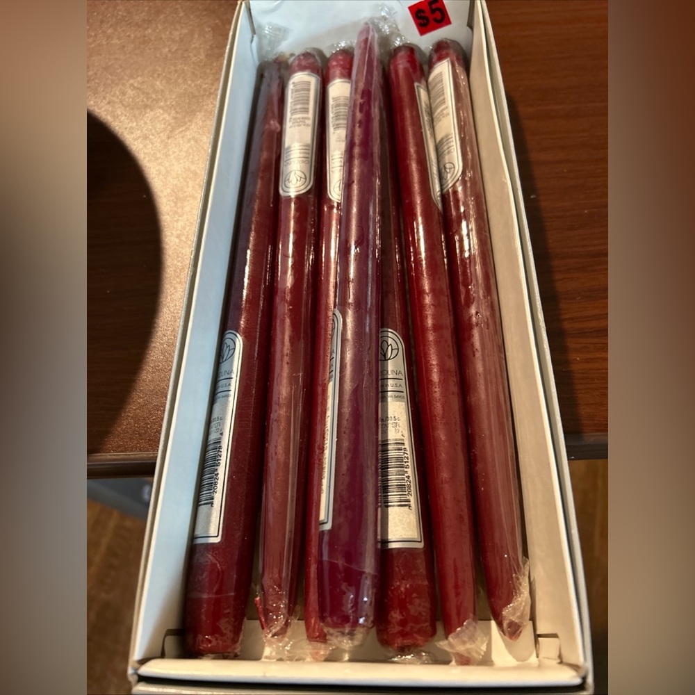 NWOT Set of 7 cranberry colored 12”Taper Candles. Perfect for fall centerpieces.